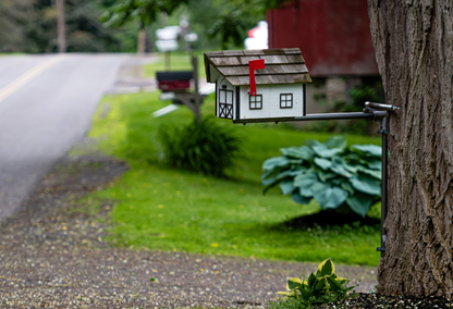 wooden mailbox on side of street